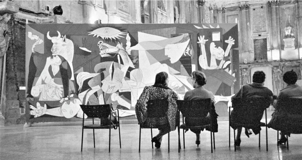 How did Picasso strengthen the effect of suffering in Guernica
